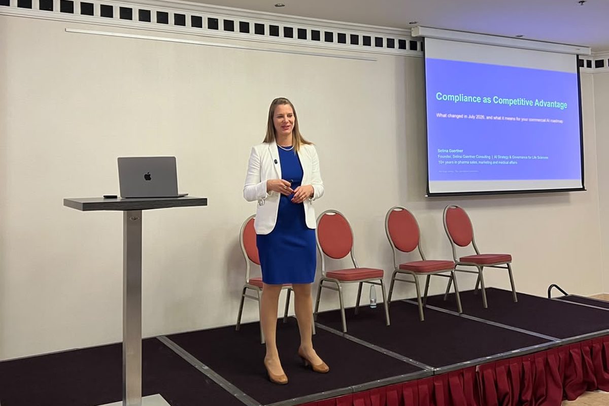 Selina Gaertner on stage in Budapest, slide on compliance as a competitive advantage visible behind her